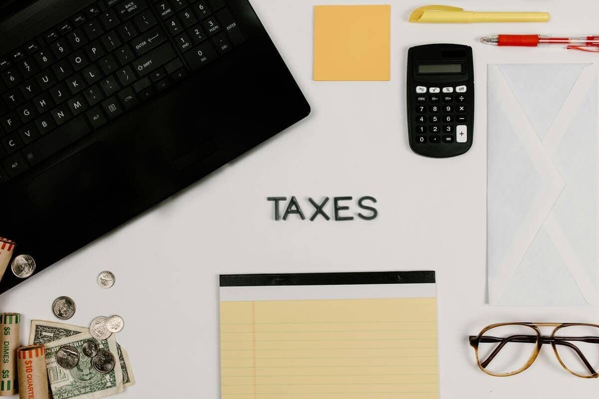 Overhead view of a desk with tax-related items and a laptop